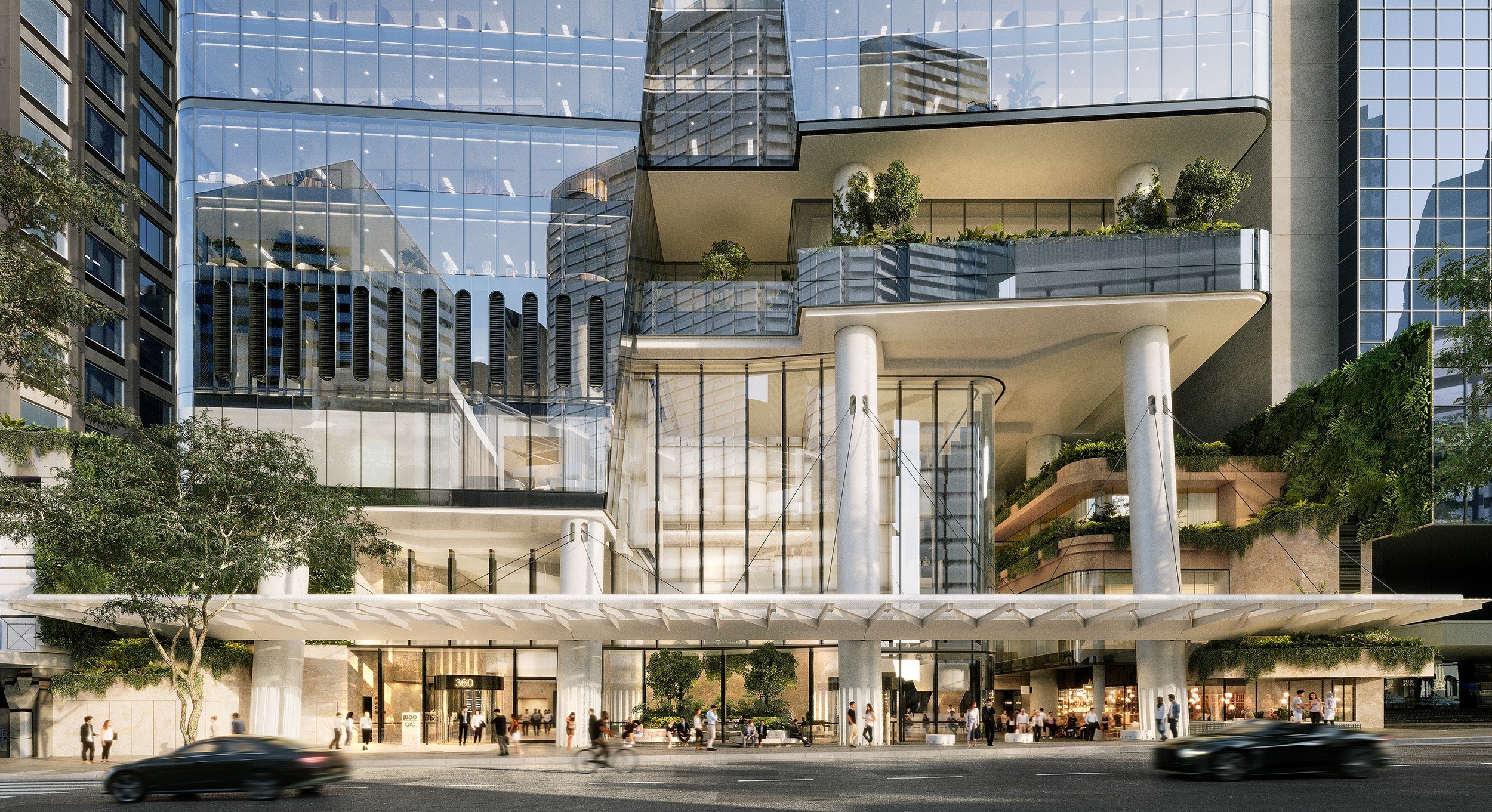 Modern mixed-use building with glass facade, white columns, tiered balconies with greenery, and ground-level retail space in urban setting.